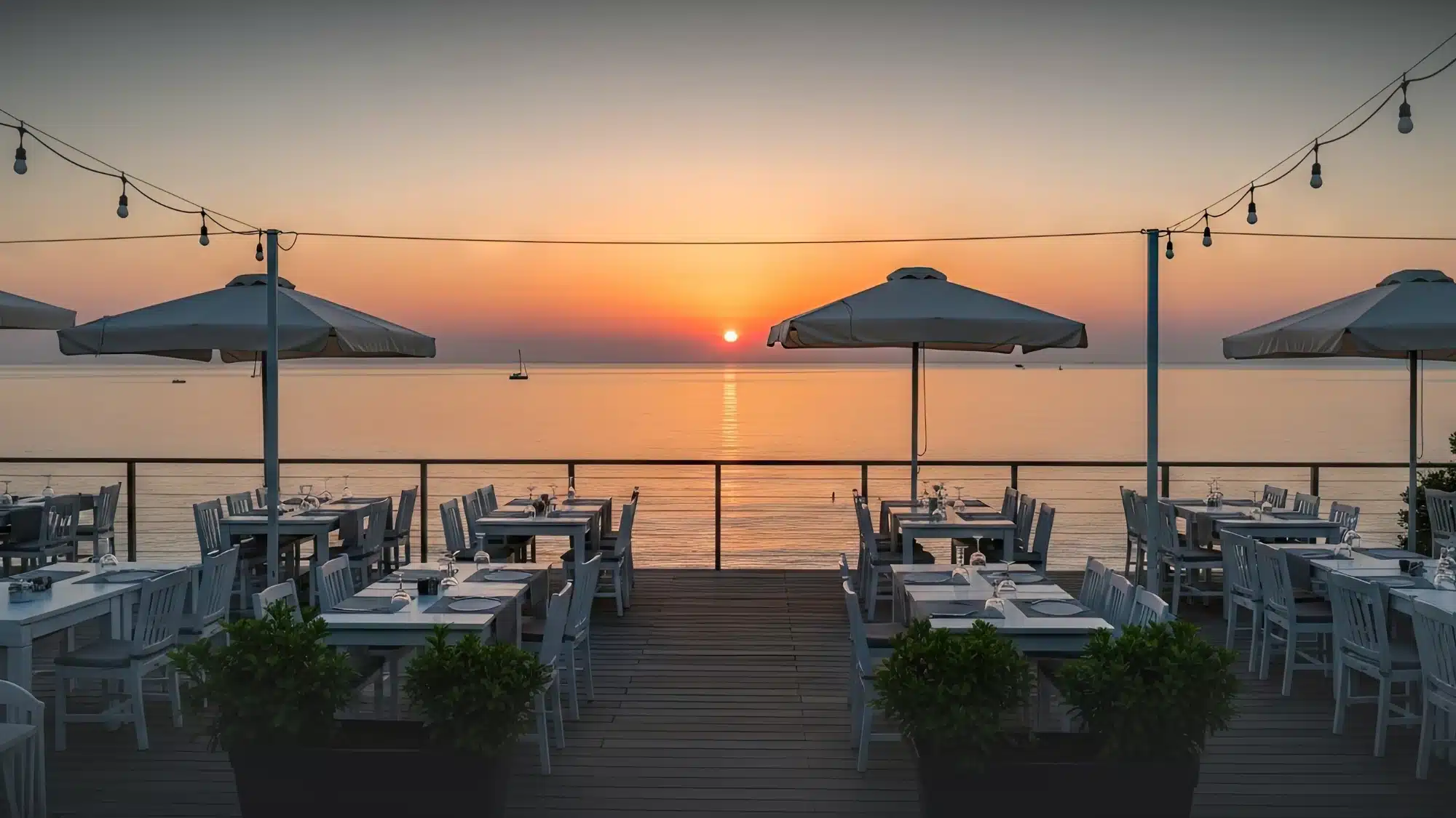 Outdoor dining at a Mystic CT restaurant with stunning waterfront views